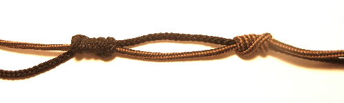 Moisten the line at the knotted areas and begin to work the two uni knots closer together.