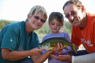 Addison and Grandparents with her Largemouth Bass